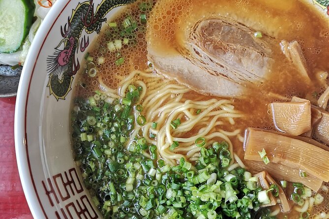 Home style Ramen and Homemade Gyoza in Kyoto - Adding cucumber pickles to the meal