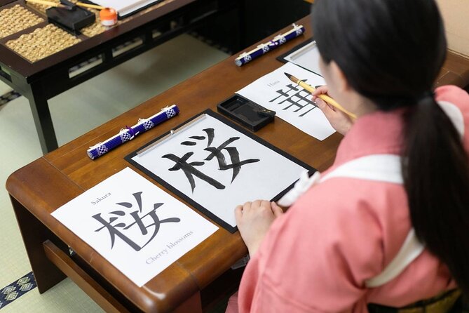 Learning Zen of Japanese Calligraphy in kimono near Osaka Castle - Choosing a kanji character with a personal meaning