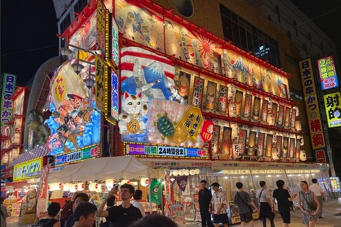 Osaka: Shinsekai Food Tour - 13 Dishes at 5 Local Eateries - Walking through Shinsekai under the neon