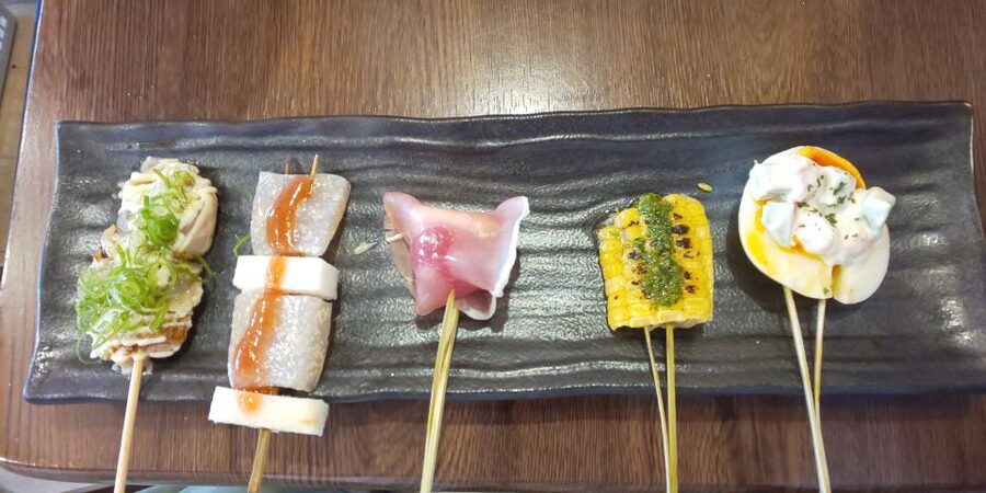 Osaka: Shinsekai Food Tour with 13-15 Dishes at 5 Eateries - The izakaya course: udon, skewers, wings, and kushikatsu