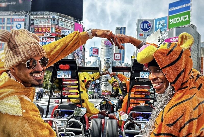 SHIBUYA CROSSING GO-KART BEST TOUR PROVIDER by ALOHA GO-KART - A low view of Tokyo, with a guide in front